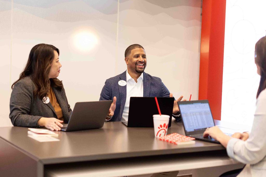 Chick-fil-A corporate staff members collaborating in an office setting.