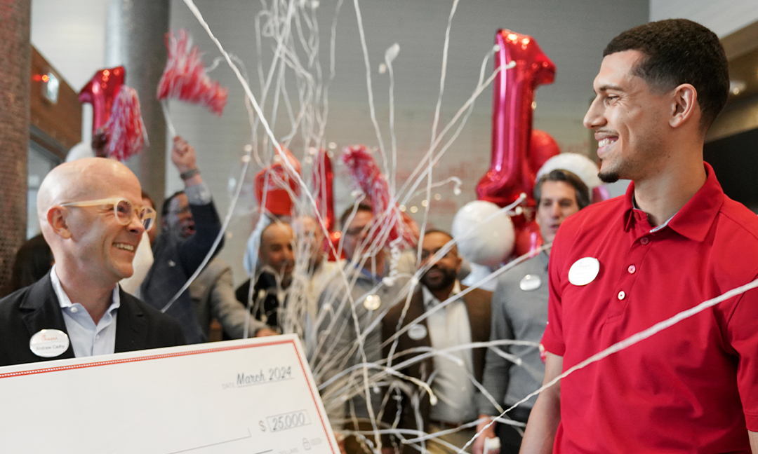 Andrew Cathy presenting a scholarship check.